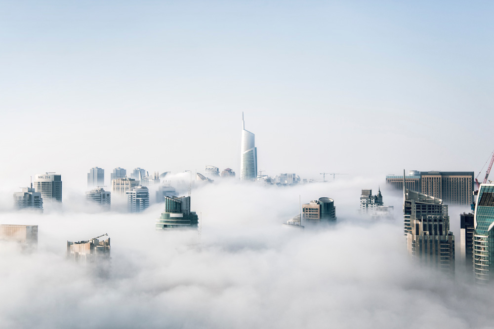 Tall building coming out of clouds