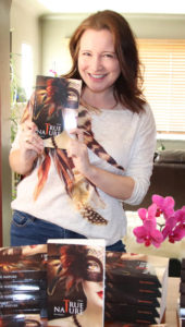 Katie holding her novel True Nature